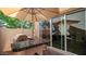 Outdoor patio with built-in bar and umbrella at 29068 N 124Th Dr, Peoria, AZ 85383