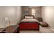 Small bedroom with red upholstered bed and chaise lounge at 29068 N 124Th Dr, Peoria, AZ 85383