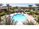 Aerial view of resort-style community pool with lounge chairs and a clubhouse at 29068 N 124Th Dr, Peoria, AZ 85383