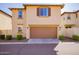 Attached garage with tan door and landscaping at 29068 N 124Th Dr, Peoria, AZ 85383