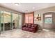Gathering room with leather couch and sliding glass doors at 29068 N 124Th Dr, Peoria, AZ 85383