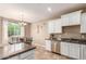 Kitchen boasts granite countertops and white cabinets at 29068 N 124Th Dr, Peoria, AZ 85383