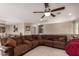 Large living room with sectional sofa and ceiling fan at 29068 N 124Th Dr, Peoria, AZ 85383