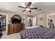 Main bedroom with king-size bed, large dresser, and walk-in closet at 29068 N 124Th Dr, Peoria, AZ 85383