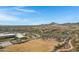 Aerial view of community with school, park, and surrounding desert landscape at 31271 N 133Rd Dr, Peoria, AZ 85383