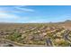 Aerial view of houses and community amenities in a sunny desert landscape at 31271 N 133Rd Dr, Peoria, AZ 85383