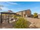 Landscaped backyard with a gazebo and desert landscaping at 31271 N 133Rd Dr, Peoria, AZ 85383