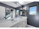 Shared bathroom with double vanity and large mirror at 31271 N 133Rd Dr, Peoria, AZ 85383