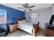 Bedroom with a double bed, dresser and ceiling fan at 31271 N 133Rd Dr, Peoria, AZ 85383