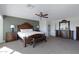 Bright bedroom with a king-size bed and en-suite bathroom at 31271 N 133Rd Dr, Peoria, AZ 85383
