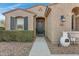 Front entrance with dark door and landscaping at 31271 N 133Rd Dr, Peoria, AZ 85383