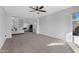 Spacious living room with large windows and ceiling fan at 31271 N 133Rd Dr, Peoria, AZ 85383