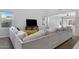 Spacious living room featuring a large sectional sofa and access to backyard at 31271 N 133Rd Dr, Peoria, AZ 85383