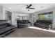 Relaxing living room with leather furniture and ceiling fan at 31271 N 133Rd Dr, Peoria, AZ 85383