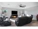 Comfortable living room with a fireplace and large TV at 31271 N 133Rd Dr, Peoria, AZ 85383