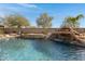 Inviting swimming pool with a cascading waterfall feature at 31271 N 133Rd Dr, Peoria, AZ 85383