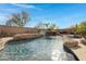 Resort-style pool with waterfall, spa, and rock features at 31271 N 133Rd Dr, Peoria, AZ 85383