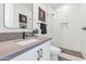 Modern bathroom with white tile shower and gray vanity at 4511 N 38Th Pl, Phoenix, AZ 85018