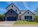 Two-story modern farmhouse with gray brick and white accents, a large driveway and landscaping at 4511 N 38Th Pl, Phoenix, AZ 85018