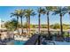 Community pool and canal view with palm trees at 4805 N Woodmere Fairway -- # 1003, Scottsdale, AZ 85251