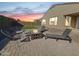 Inviting backyard featuring a patio with a fire pit and lounge chairs at 6807 W Winston Dr, Laveen, AZ 85339