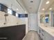 Modern bathroom featuring a glass-enclosed shower, dual sinks, and contemporary fixtures at 6807 W Winston Dr, Laveen, AZ 85339