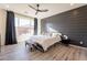 Main bedroom with dark gray shiplap accent wall and wood-look flooring at 6807 W Winston Dr, Laveen, AZ 85339