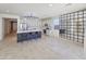 Spacious kitchen with a large island, white cabinetry, stainless steel appliances, and unique grid-style accent wall at 6807 W Winston Dr, Laveen, AZ 85339