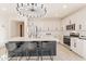Modern kitchen with white cabinets, large island with seating and stainless steel appliances at 6807 W Winston Dr, Laveen, AZ 85339