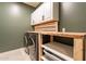 Laundry room with washer, dryer, and wood shelving at 6807 W Winston Dr, Laveen, AZ 85339