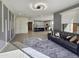 Open-concept living room flowing into the kitchen, with stylish decor and ample natural light at 6807 W Winston Dr, Laveen, AZ 85339