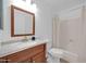 Clean bathroom with wood vanity and a bathtub shower combo at 6934 W Orange Dr, Glendale, AZ 85303