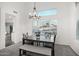 Charming dining room with a table, bench and chandelier at 7270 Nw Tina Ln, Glendale, AZ 85310