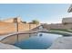 Inviting kidney-shaped pool with a basketball hoop in the backyard at 7270 Nw Tina Ln, Glendale, AZ 85310