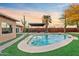Inviting kidney-shaped pool with a pergola and grassy area at 7918 E Dale Ln, Scottsdale, AZ 85266