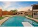 Stunning kidney-shaped pool with diving board and surrounding patio at 7918 E Dale Ln, Scottsdale, AZ 85266