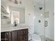 Modern bathroom with a walk-in shower, toilet and dark brown vanity at 7918 E Dale Ln, Scottsdale, AZ 85266