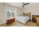 Guest bedroom with wood flooring, a queen-size bed, and natural light at 7918 E Dale Ln, Scottsdale, AZ 85266