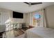 Charming bedroom with wood floors, a comfortable bed, and a large window at 7918 E Dale Ln, Scottsdale, AZ 85266