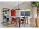 Cozy dining area, featuring a wooden table and chairs, near a red telephone booth at 7918 E Dale Ln, Scottsdale, AZ 85266