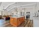 Open kitchen with island, hardwood floors, and modern lighting fixtures at 7918 E Dale Ln, Scottsdale, AZ 85266