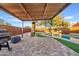 Spacious patio with a pergola, grill, and views of the pool at 7918 E Dale Ln, Scottsdale, AZ 85266