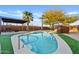 Inviting kidney-shaped pool with a paved patio and lush landscaping at 7918 E Dale Ln, Scottsdale, AZ 85266
