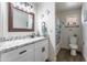 Bright bathroom featuring granite countertops, updated fixtures, and sea-themed decor at 8039 E Madero Ave, Mesa, AZ 85209