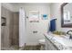Bright bathroom showcasing updated fixtures, a granite countertop, and a tiled shower with built-in niche at 8039 E Madero Ave, Mesa, AZ 85209