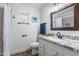 Bright bathroom with granite countertop, a framed mirror, updated fixtures, and a tiled shower at 8039 E Madero Ave, Mesa, AZ 85209