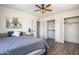 Bedroom featuring a closet, wood-look flooring, a ceiling fan, and a decorative painting at 8039 E Madero Ave, Mesa, AZ 85209
