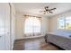 Bedroom features a closet, wood-look flooring, and a large window at 8039 E Madero Ave, Mesa, AZ 85209