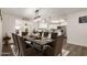 An inviting dining room with modern lighting is situated adjacent to the kitchen at 8039 E Madero Ave, Mesa, AZ 85209