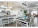 Stylish dining room with wooden table, seating for six, and adjacent breakfast bar area at 8039 E Madero Ave, Mesa, AZ 85209